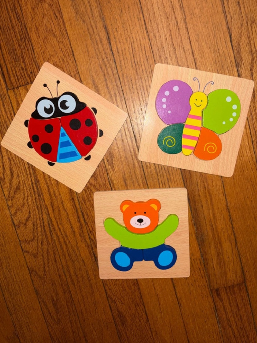 Set of three wooden puzzles, bear ladybug butterfly